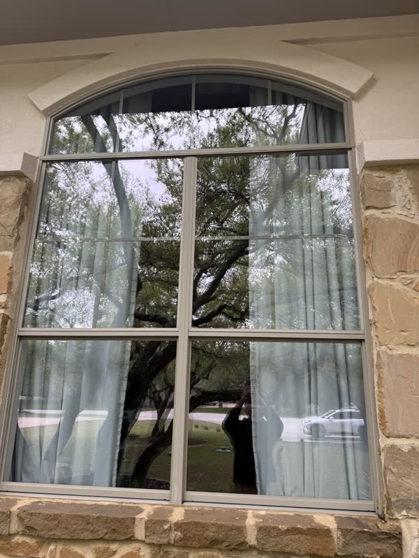 Arched stone-trim window in Houston, by Rinse & Shine