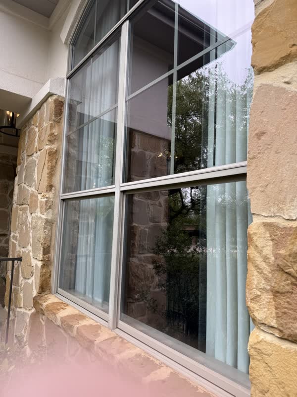 Tall stone-trim windows in Houston, by Rinse & Shine
